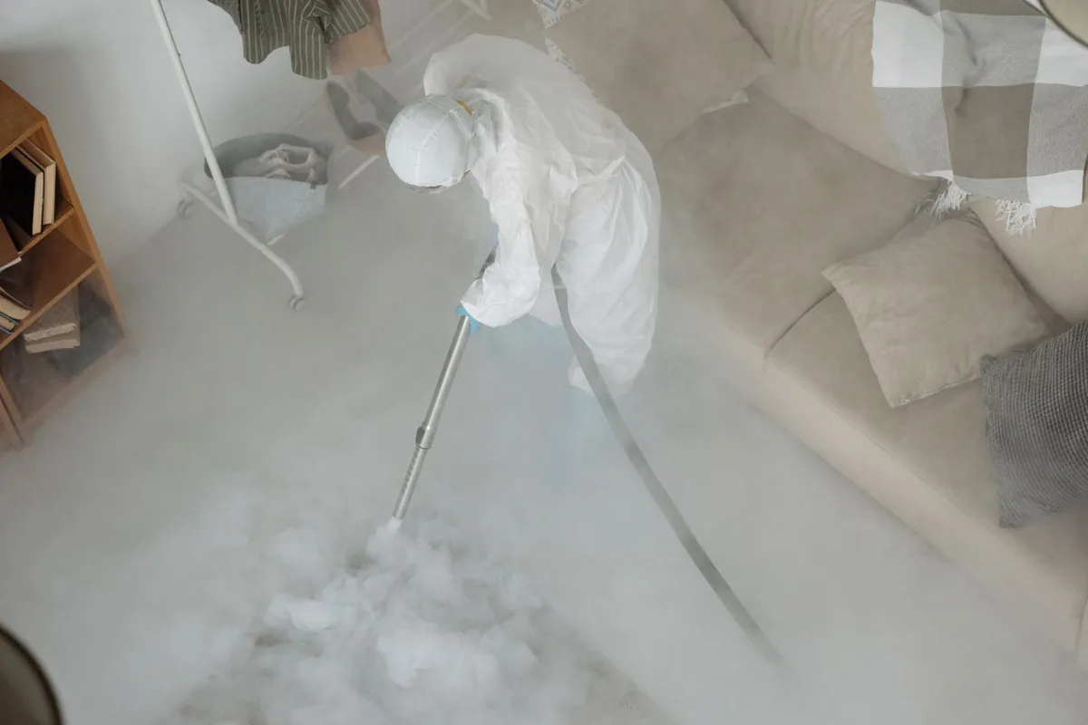 Biohazard cleanup technician in protective equipment, Hemlock, MI